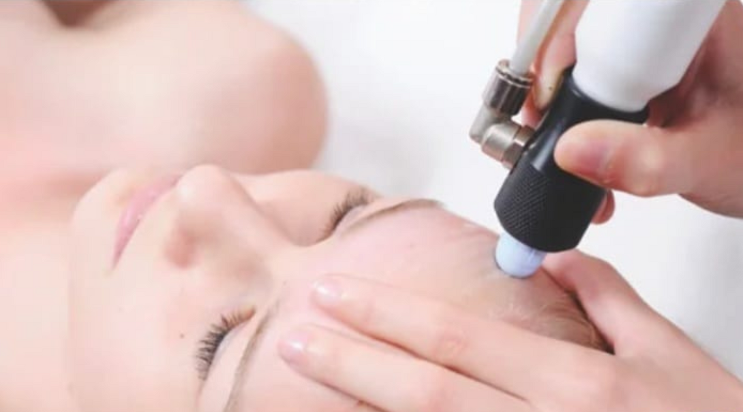 Woman having a microdermabraision treatment done on her forehead